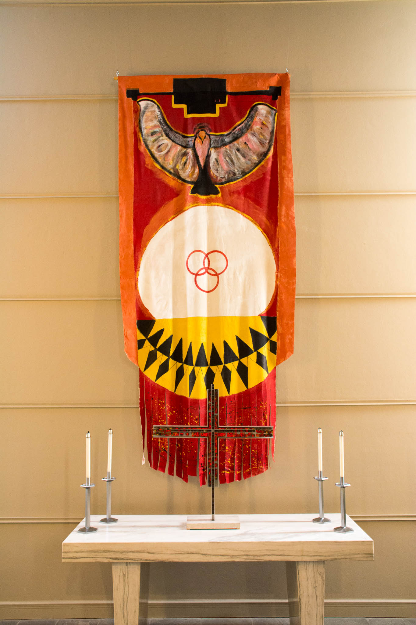 In this dramatic vertical banner, an eagle pulls a white circle upward against an orange background.