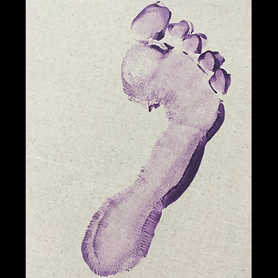 Footprint made with purple paint on a cream-colored canvas.