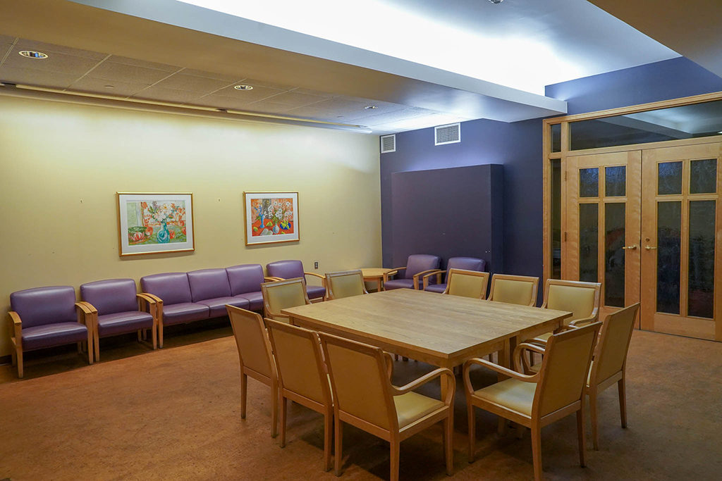 View of the Fireside Room from the back shows the glass doors and a conference table that seats 10.