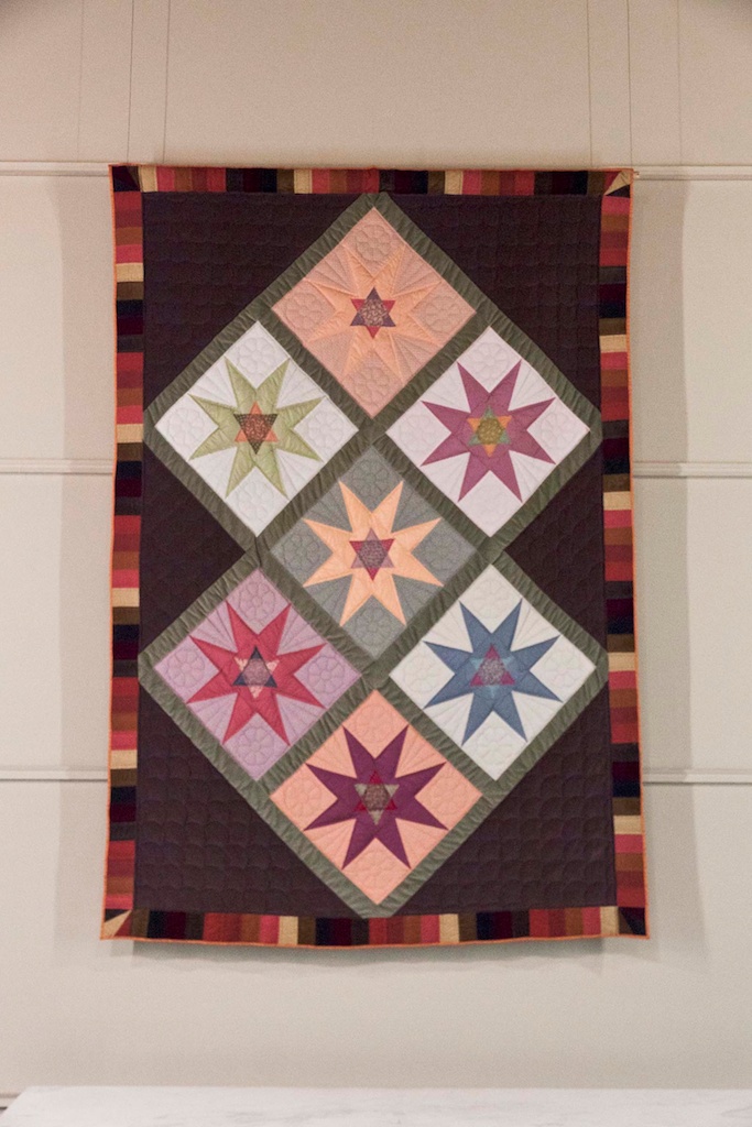 A large quilt hangs on the wall of the UniLu chancel.