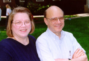 Wendell Rhine and Phyllis Steele smile for the camera in a sunny outdoor setting.